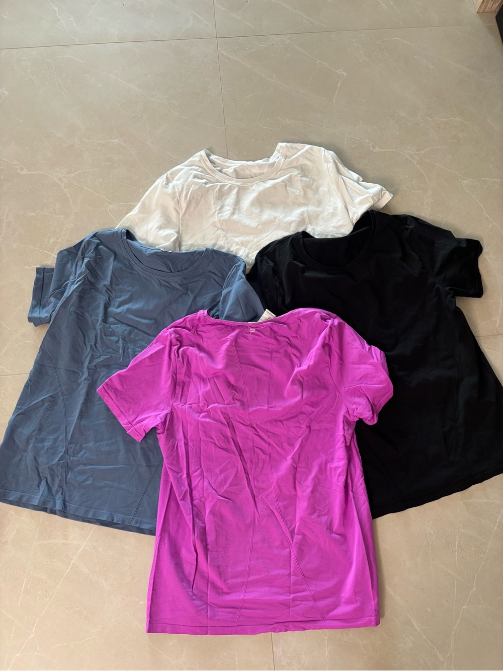 Fabletics Short sleeve Activewear Crew Tees in White, Black, Gray, and Magenta
